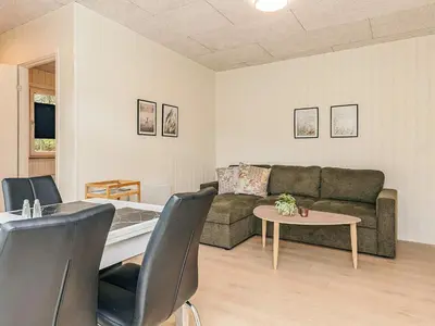 a living room with a couch and a table at 5 person holiday park home in Pandrup in Pandrup