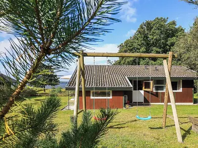 a house with a swing in front of it at 8 person holiday home in Skals-By Traum in Skals