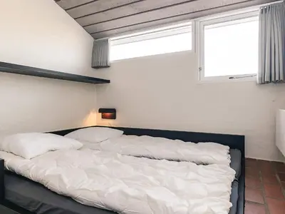 a large bed in a room with a window at 6 person holiday home in Brovst in Brovst