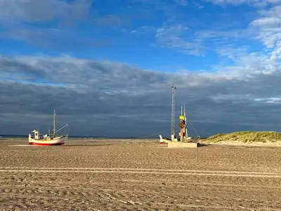 two boats sitting on the shore of a beach at 6 person holiday home in Brovst in Brovst