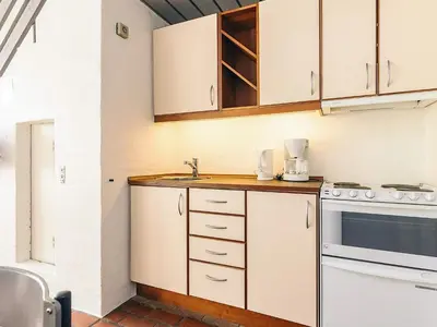 a kitchen with white cabinets and a sink at 6 person holiday home in Brovst in Brovst