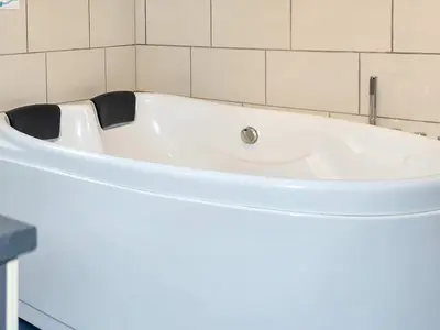 a white bath tub sitting in a bathroom at 4 star holiday home in Farsø-By Traum in Farsø