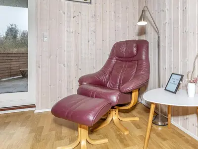 a brown leather chair sitting next to a table at 4 star holiday home in Farsø-By Traum in Farsø