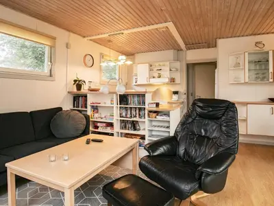 a living room with a couch and a table at 5 person holiday home in Thyholm-By Traum in Thyholm
