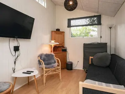 a living room with a couch and a flat screen tv at 5 person holiday home in Thyholm-By Traum in Thyholm