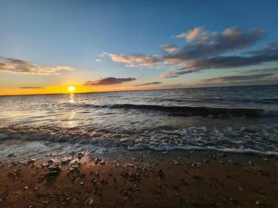 a sunset on a beach with the ocean at 6 person holiday home in Vinderup-By Traum in Vinderup