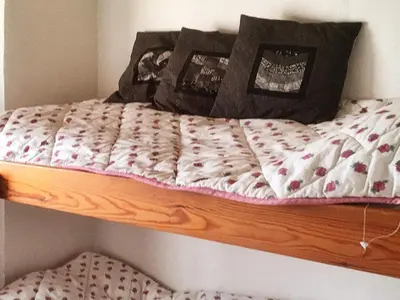 a wooden bunk bed with a comforter on it at 6 person holiday home in Vinderup-By Traum in Vinderup