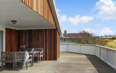 a patio with a table and chairs on a deck at 4 Bedroom Beautiful Home In Thisted in Thisted