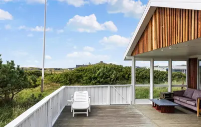 a porch with a couch and chairs on it at 4 Bedroom Beautiful Home In Thisted in Thisted