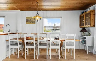 a dining room with a table and white chairs at 4 Bedroom Beautiful Home In Thisted in Thisted
