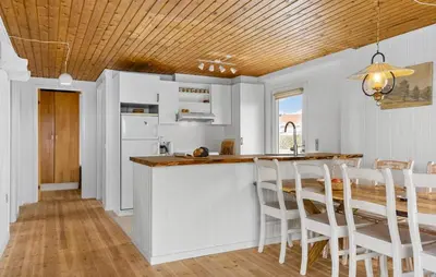 a kitchen with a wooden ceiling and a table and chairs at 4 Bedroom Beautiful Home In Thisted in Thisted