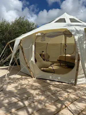 a white tent with a chair in it at Agger Glamping - Havtornen in Vestervig