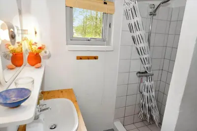 a white bathroom with a shower and a sink at 1333-Thisted-Sandtornvej-43 in Thisted