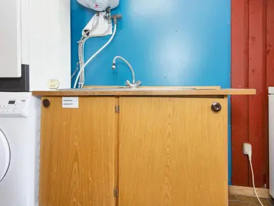 a kitchen with a sink and a blue wall at 10 person holiday home in Harboøre-By Traum in Harboør