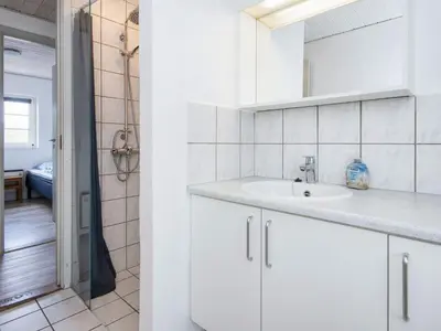 a white bathroom with a sink and a mirror at 12 person holiday home in Harboøre-By Traum in Harboør