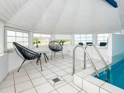 a room with a pool and two chairs and a table at 12 person holiday home in Harboøre-By Traum in Harboør