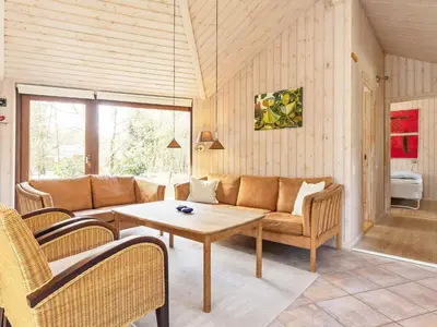 a living room with a couch and a table at 8 person holiday home in Fjerritslev-By Traum in Fjerritslev