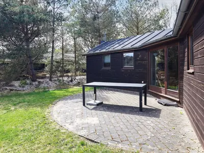 a ping pong table sitting outside of a house at 8 person holiday home in Fjerritslev-By Traum in Fjerritslev