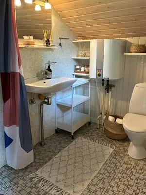 a bathroom with a sink and a toilet at Family Cabin By The Calm Waters Of Limfjord in Højslev