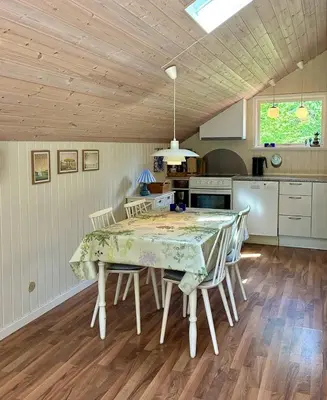a dining room table and chairs in a kitchen at Family Cabin By The Calm Waters Of Limfjord in Højslev