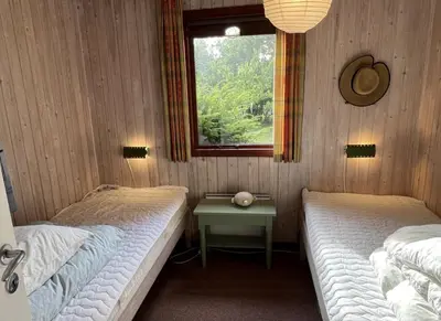 two twin beds in a room with a window at Holiday Home By Limfjord With Historic Charm in Farsø