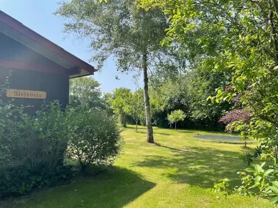 a yard with a tree and a building at Holiday Home By Limfjord With Historic Charm in Farsø