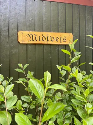 a sign on a fence that says miracles at Holiday Home By Limfjord With Historic Charm in Farsø