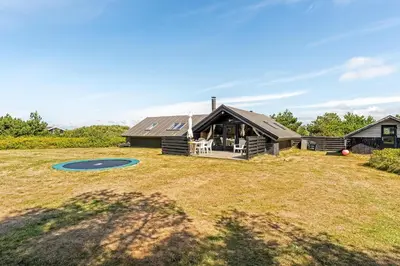 a home with a large yard with a house at Lovely Holiday Home With Wood-Burning Stove, Close To The North Sea In Klitmøller in Thisted