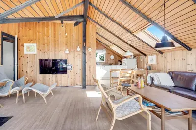 a living room with a couch and a table at Lovely Holiday Home With Wood-Burning Stove, Close To The North Sea In Klitmøller in Thisted