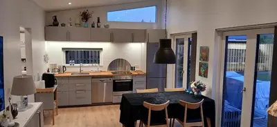 a kitchen with a table and chairs in a room at Blokhus - tæt på by og strand in Blokhus