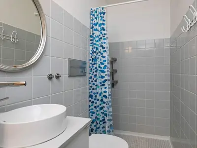 a bathroom with a sink and a shower at 4-person cabin in Lemvig holiday park in Lemvig