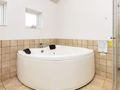 a white bath tub in a bathroom with a window at 8 person holiday home in Brovst-By Traum in Brovst