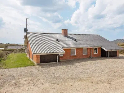 a red brick house on a dirt lot at 12 person holiday home in Vestervig-By Traum in Vestervig