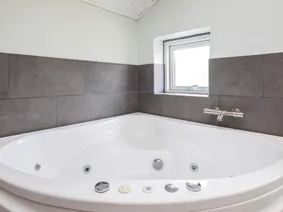 a white bath tub in a bathroom with a window at 12 person holiday home in Vestervig-By Traum in Vestervig