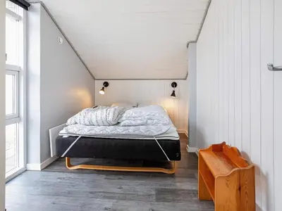 a small bedroom with a bed in a attic at 12 person holiday home in Vestervig-By Traum in Vestervig