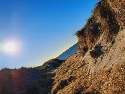 a dirt hill with grass on the side of it at 8 person holiday home in Harboøre-By Traum in Harboør