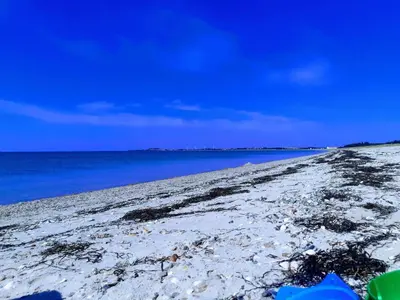 a sandy beach with the ocean and the sky at 7 person holiday home in Løgstør-By Traum in Løgstør