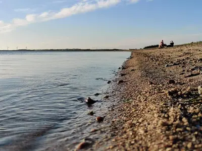 a group of people standing on a beach near the water at 7 person holiday home in Løgstør-By Traum in Løgstør