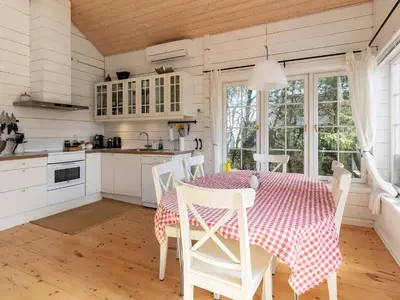 a kitchen with a table with a red and white table cloth at 7 person holiday home in Løgstør-By Traum in Løgstør