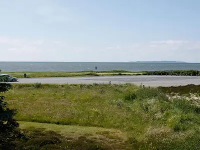 a road with the ocean in the background at 7 person holiday home in Løgstør-By Traum in Løgstør