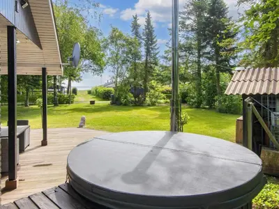 a ping pong table sitting on a wooden deck at 6 person holiday home in Thyholm-By Traum in Thyholm