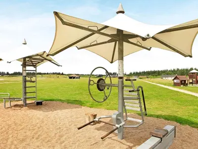 a playground with a white umbrella and a swing at 16 person holiday home in Brovst-By Traum in Brovst