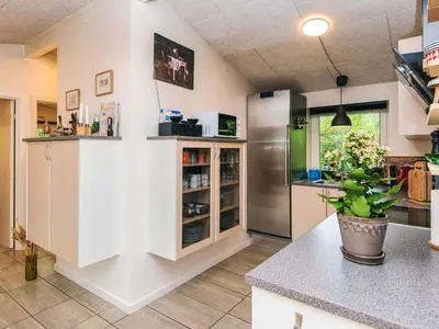 a kitchen with white cabinets and a refrigerator at 7 person holiday home in Hurup Thy-By Traum in Sønder Ydby
