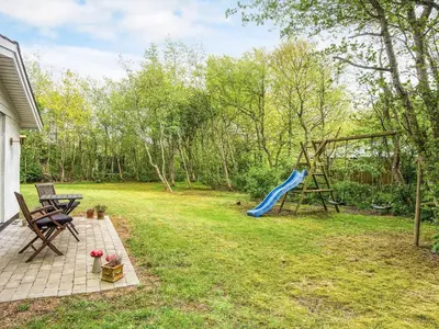 a backyard with a slide and a playground at 7 person holiday home in Hurup Thy-By Traum in Sønder Ydby