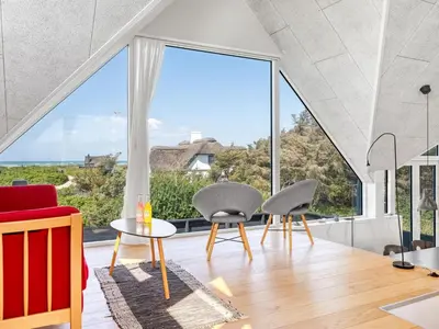 a room with a large window and two chairs and a table at Holiday Home Tekla - 180m from the sea by Interhome in Blokhus