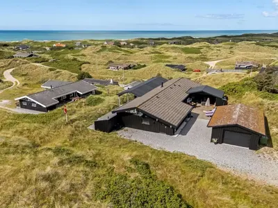 an overhead view of a house with the ocean in the background at Holiday Home Jannus - 600m from the sea by Interhome in Saltum