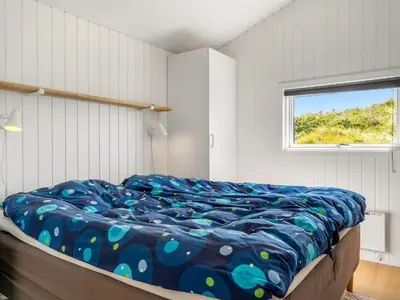 a bed in a room with a window at Holiday Home Jannus - 600m from the sea by Interhome in Saltum