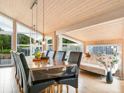 a dining room with a table and chairs at Holiday Home Eeske - 2-5km from the sea by Interhome in Blokhus