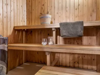 a wooden shelf in a sauna with two glasses at Holiday Home Melisa - 3km from the sea by Interhome in Pandrup