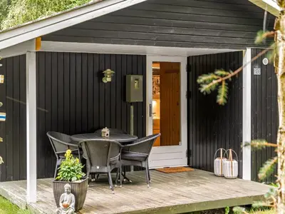 a patio with a table and chairs on a deck at Holiday Home Melisa - 3km from the sea by Interhome in Pandrup